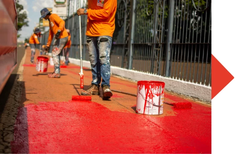 Hombre pintando el suelo de color rojo